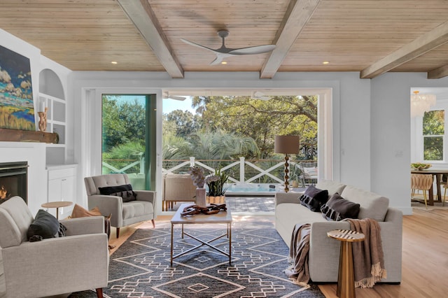 living room with beamed ceiling, wood-type flooring, wooden ceiling, and a healthy amount of sunlight