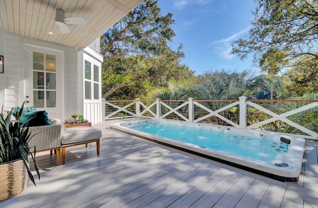 view of pool with ceiling fan and a wooden deck