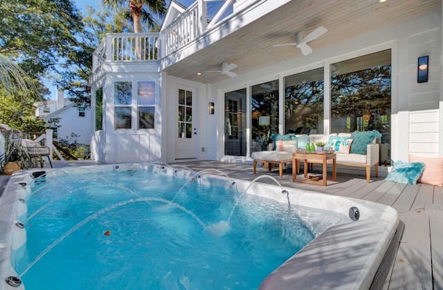 view of pool featuring an outdoor living space and ceiling fan