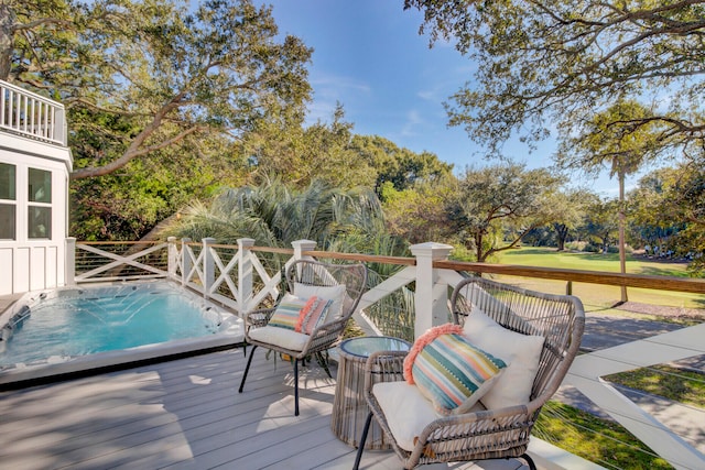 wooden deck with a hot tub