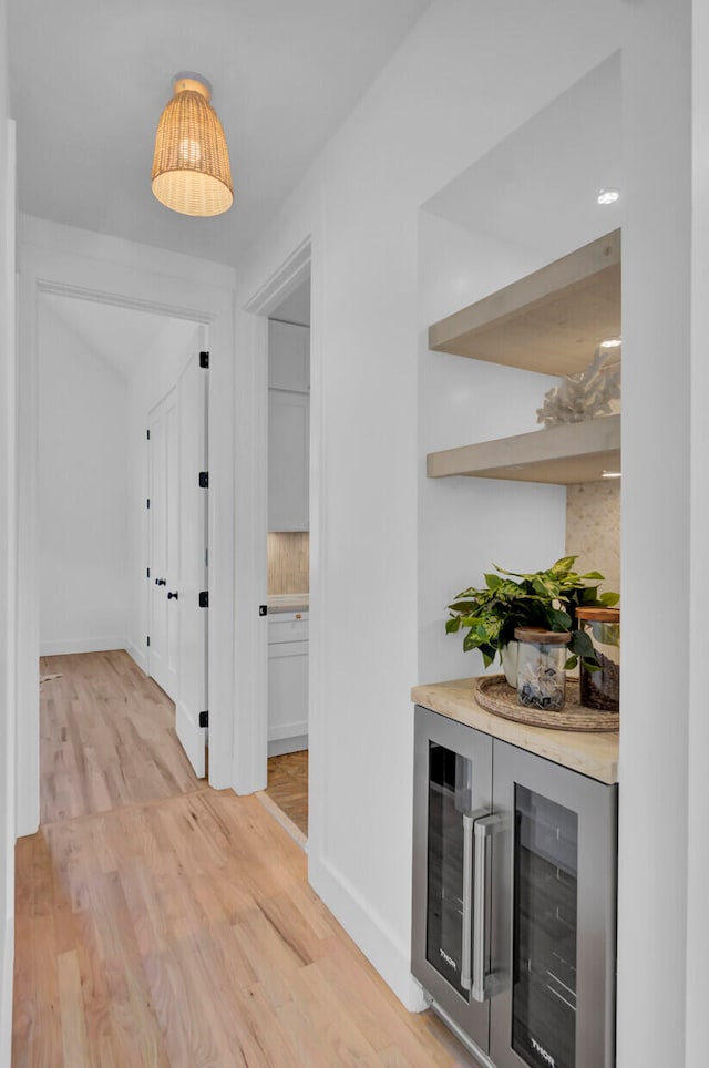 hall with wine cooler and light hardwood / wood-style floors