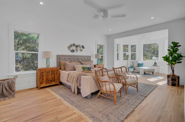 bedroom with light wood-type flooring and ceiling fan