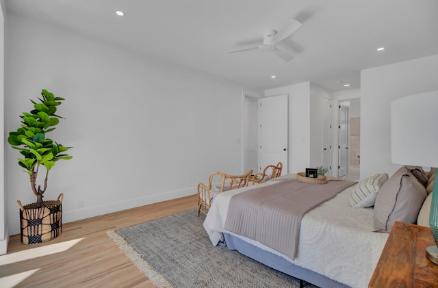 bedroom with light hardwood / wood-style floors, ceiling fan, and ensuite bathroom