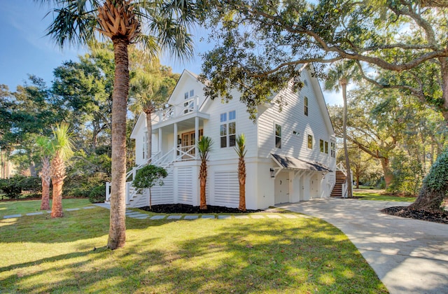 view of property exterior featuring covered porch, a lawn, a garage, and a balcony