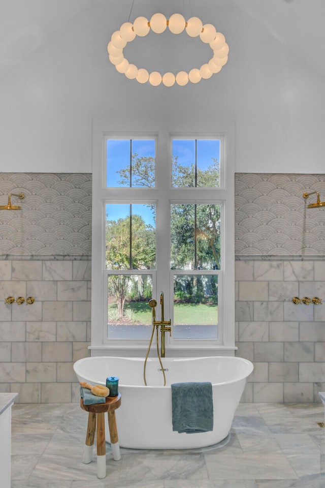 bathroom with tile walls and a bathtub