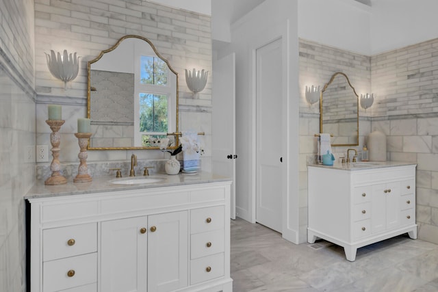 bathroom featuring vanity and tile walls