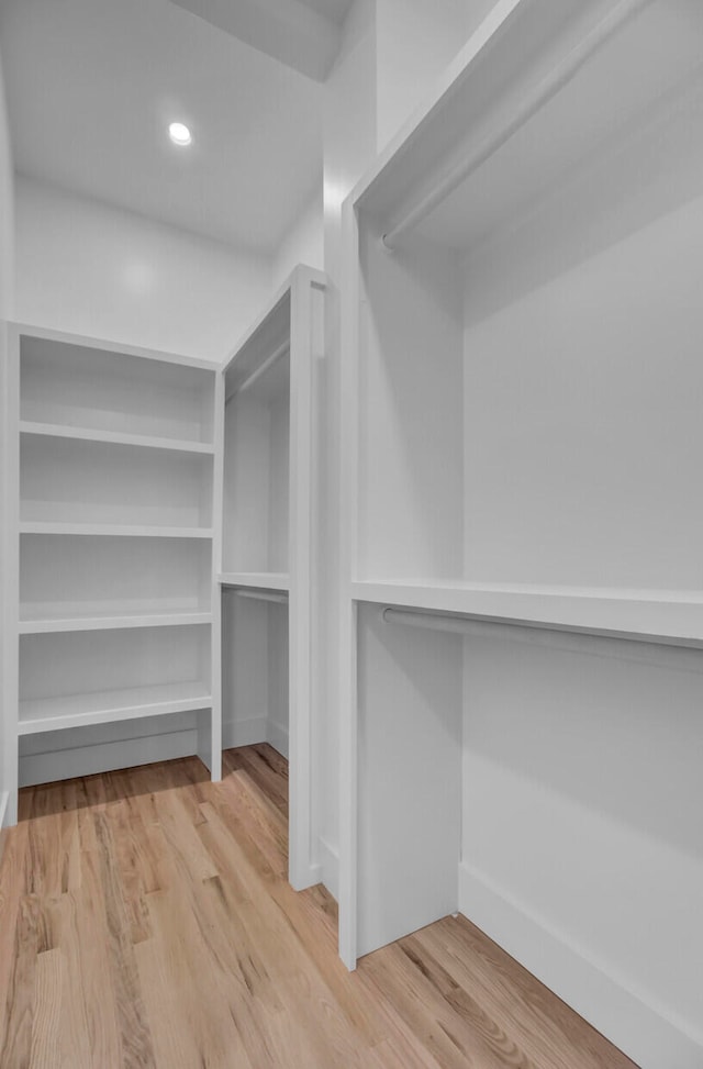 spacious closet featuring hardwood / wood-style flooring