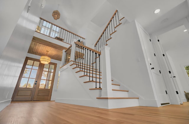 entrance foyer featuring a wealth of natural light, french doors, and wood-type flooring