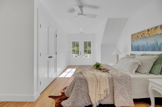 bedroom featuring access to outside, ceiling fan, light wood-type flooring, and french doors