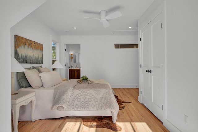 bedroom with ensuite bath, ceiling fan, and light wood-type flooring