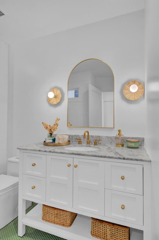 bathroom with tile patterned floors, vanity, and toilet