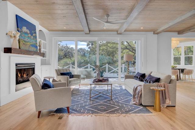 living room with wood ceiling, hardwood / wood-style floors, and a healthy amount of sunlight