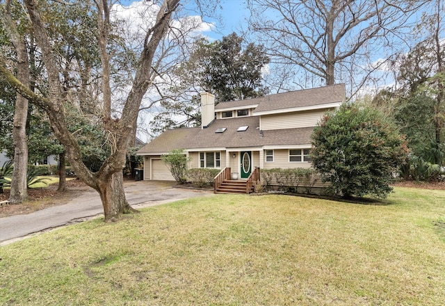 view of front of home with a garage and a front lawn