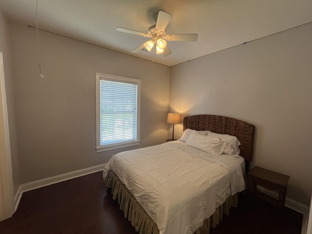 bedroom with dark wood-style flooring, baseboards, and ceiling fan