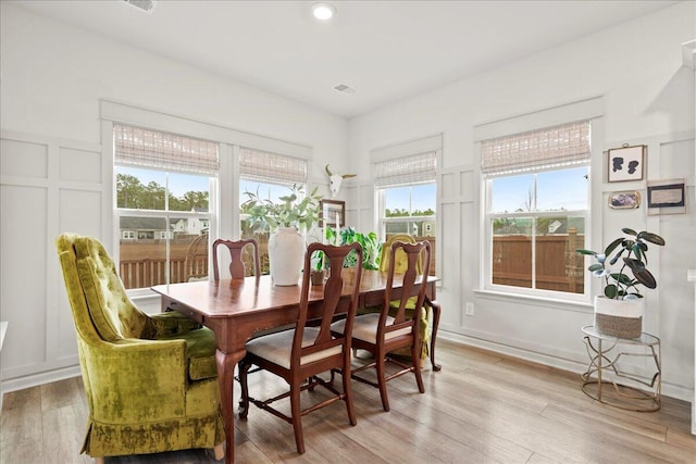 dining space featuring plenty of natural light and light wood-type flooring