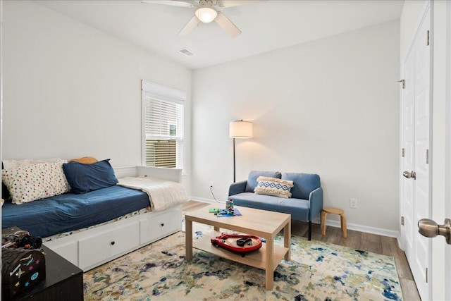 living room featuring ceiling fan and wood-type flooring