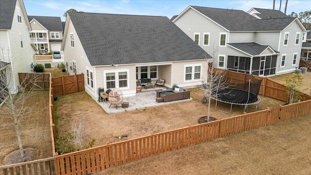 back of property featuring a trampoline, a patio area, and outdoor lounge area