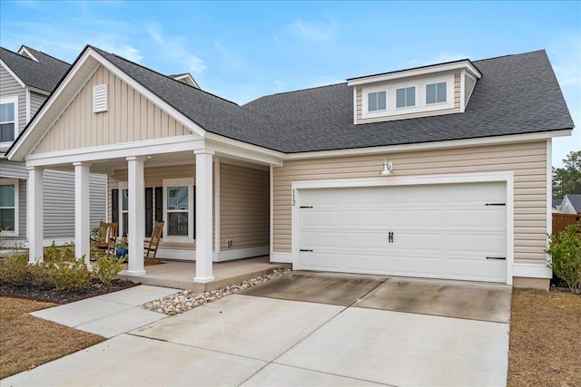 view of front of home featuring covered porch and a garage