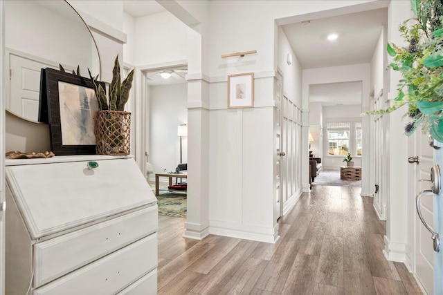 corridor with light hardwood / wood-style floors