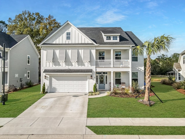 view of front of property with a garage, a balcony, and a front lawn