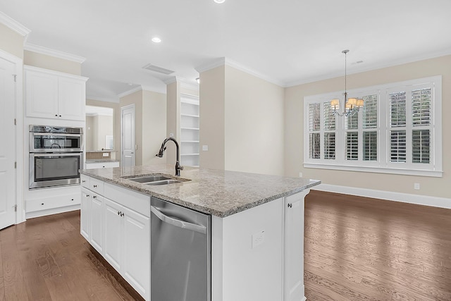 kitchen with visible vents, a sink, dark wood-type flooring, appliances with stainless steel finishes, and crown molding