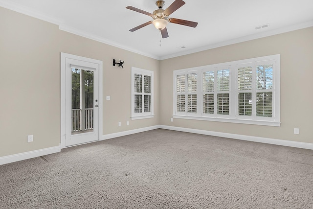 unfurnished room featuring crown molding, baseboards, visible vents, and ceiling fan