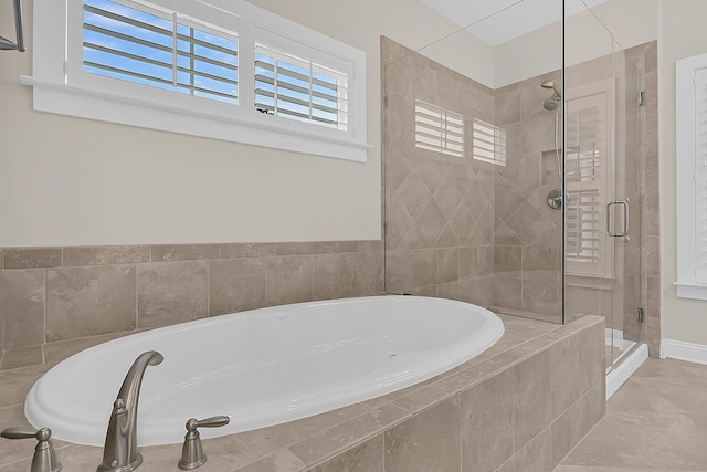 full bath featuring a garden tub and a shower stall