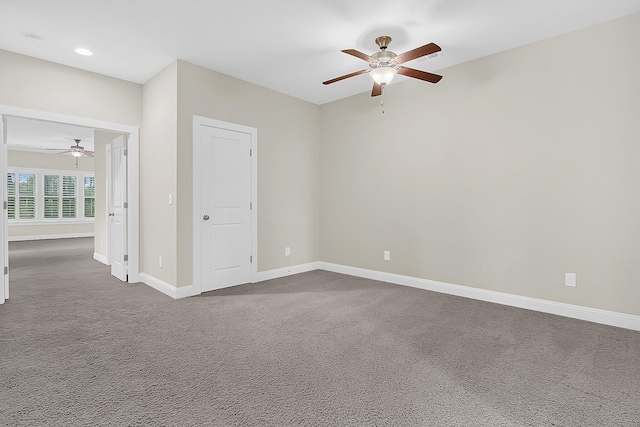 spare room with recessed lighting, baseboards, a ceiling fan, and dark carpet