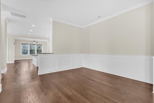 unfurnished room featuring visible vents, a wainscoted wall, ornamental molding, recessed lighting, and dark wood-style floors