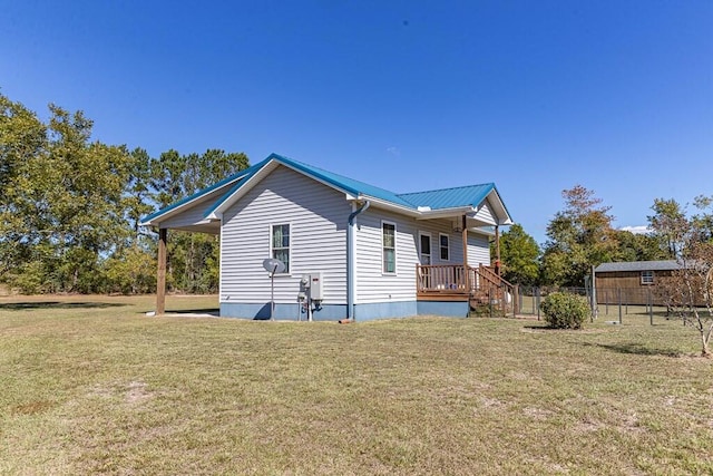 rear view of house with a shed and a yard