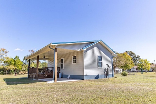 rear view of house with a patio area, a lawn, and ceiling fan