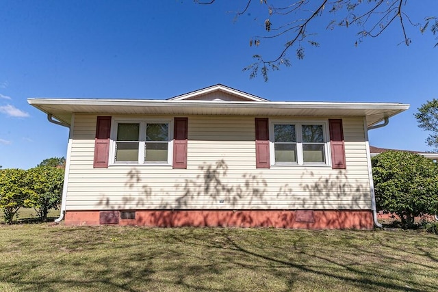 view of property exterior with a yard