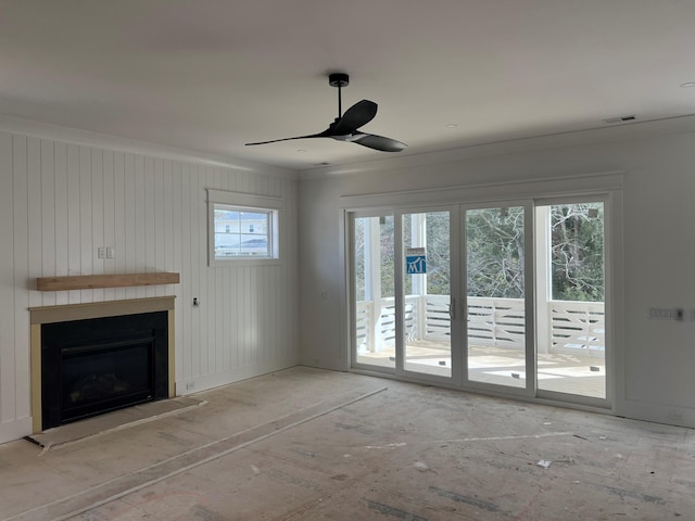 unfurnished living room with ornamental molding and ceiling fan