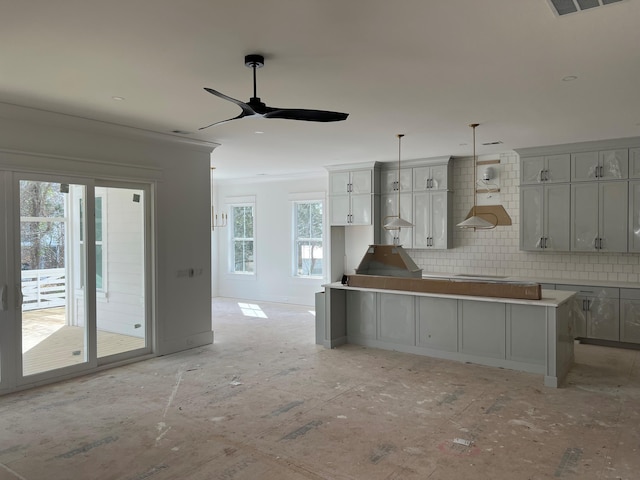 kitchen featuring gray cabinets, pendant lighting, backsplash, a center island, and ceiling fan