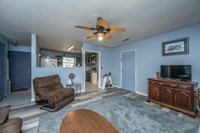 1004 Miles Jamison Rd, Summerville, SC 29485 - living area featuring wood finished floors, a ceiling fan, a textured ceiling, and baseboards
