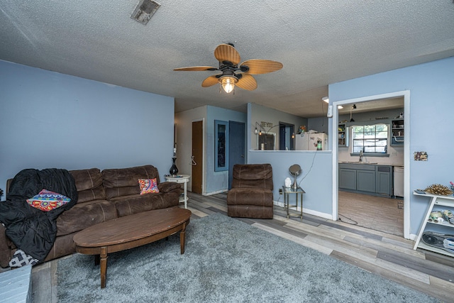 1004 Miles Jamison Rd, Summerville, SC 29485 - living area featuring ceiling fan, wood finished floors, and a textured ceiling