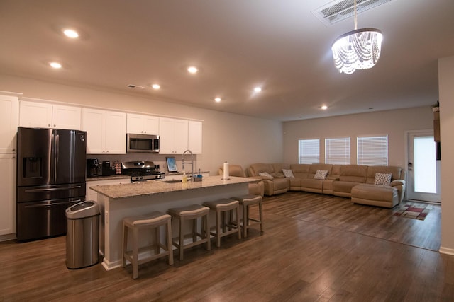 217 Pink Azalea St, Summerville, SC 29485 - kitchen featuring a breakfast bar, open floor plan, white cabinetry, stainless steel appliances, and a sink