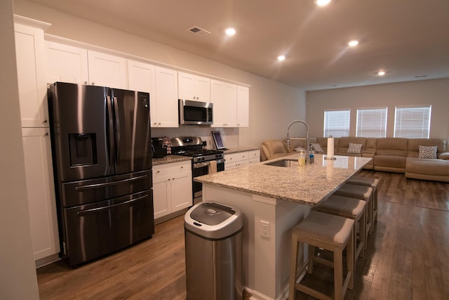 217 Pink Azalea St, Summerville, SC 29485 - kitchen featuring dark wood-type flooring, white cabinetry, a kitchen island with sink, a sink, and stainless steel appliances