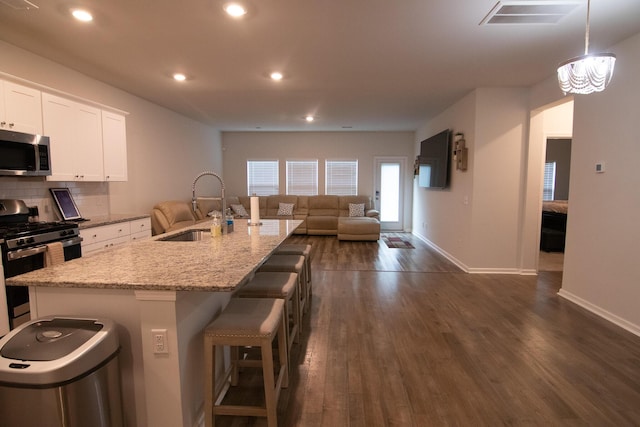 217 Pink Azalea St, Summerville, SC 29485 - kitchen with a kitchen breakfast bar, dark wood-type flooring, visible vents, appliances with stainless steel finishes, and a sink
