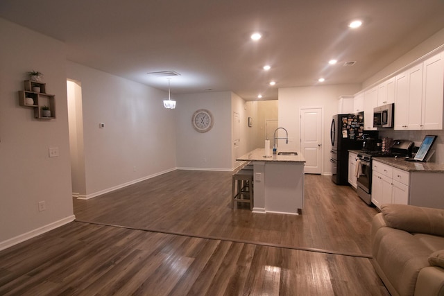 217 Pink Azalea St, Summerville, SC 29485 - kitchen featuring white cabinets, a sink, open floor plan, a breakfast bar, and stainless steel appliances