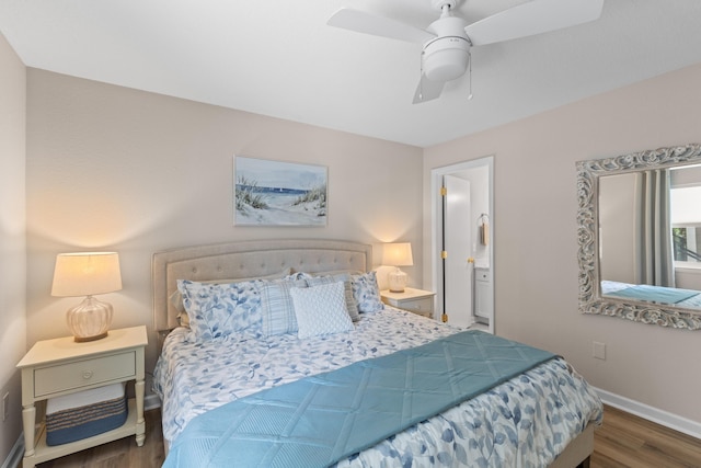 bedroom featuring ceiling fan, ensuite bath, wood finished floors, and baseboards