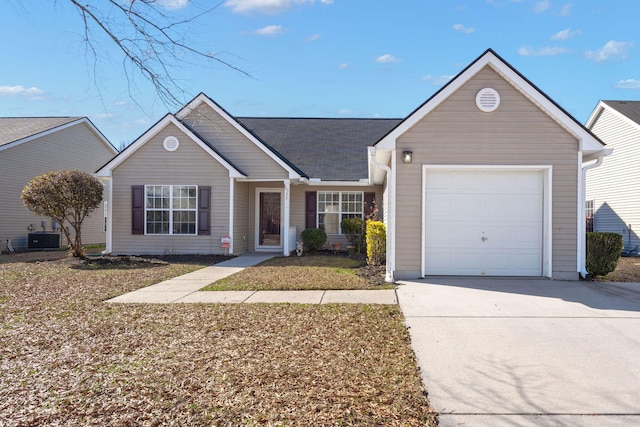 ranch-style house with driveway, an attached garage, and central air condition unit