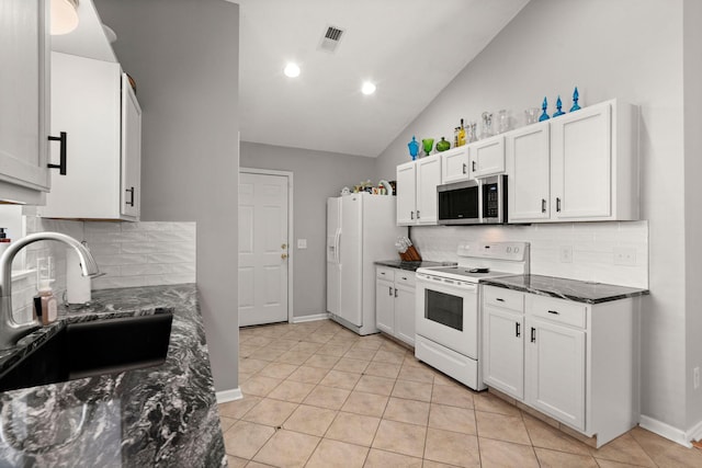 kitchen featuring white appliances, white cabinetry, and a sink