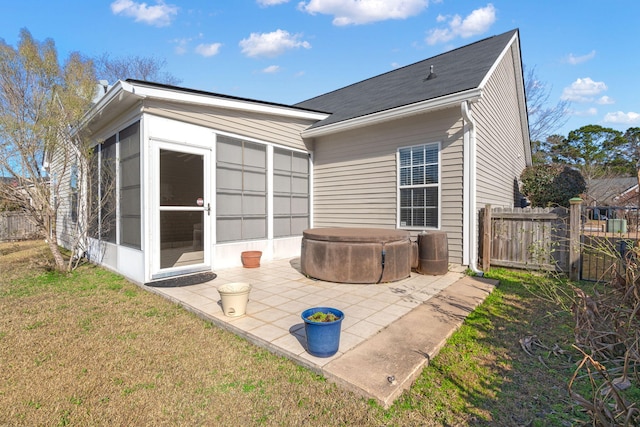 back of property with fence private yard, a patio area, and a lawn