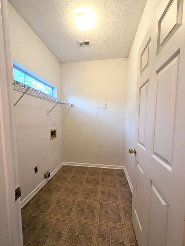 clothes washing area featuring gas dryer hookup, hookup for an electric dryer, washer hookup, and a textured ceiling