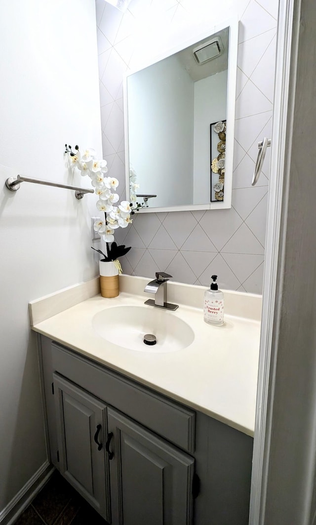 bathroom with vanity and decorative backsplash