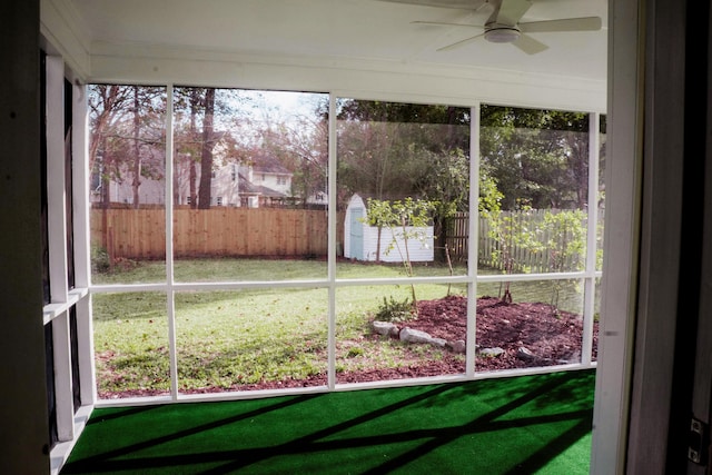 unfurnished sunroom with ceiling fan