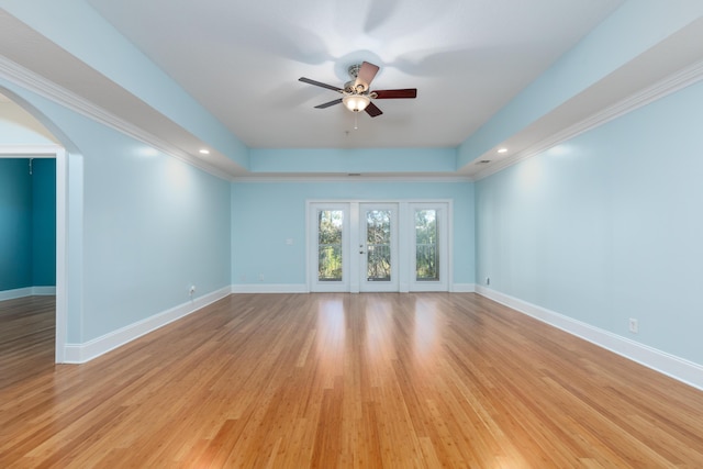 unfurnished living room featuring light wood-type flooring, ceiling fan, and crown molding