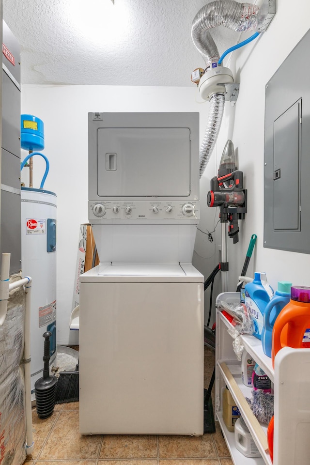 laundry area with a textured ceiling, electric panel, stacked washer and dryer, and electric water heater