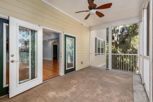 unfurnished sunroom featuring ceiling fan